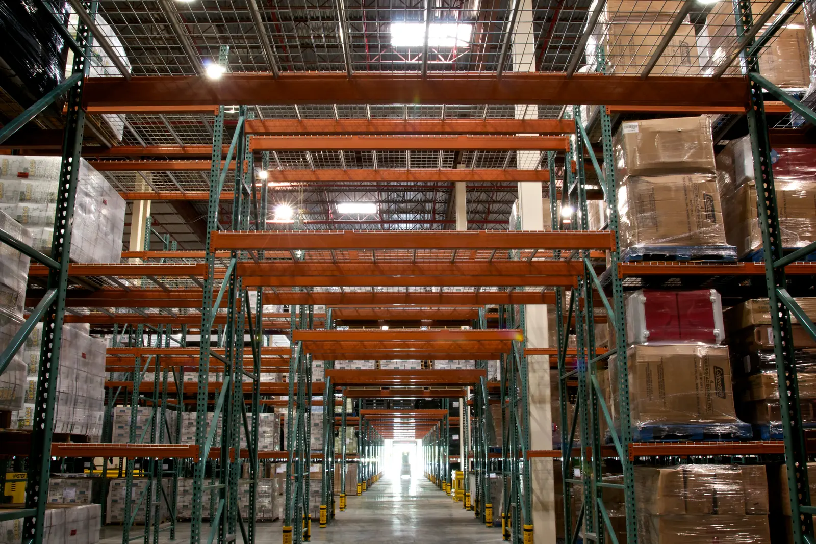 Large distribution center interior with pallet racks and stored goods