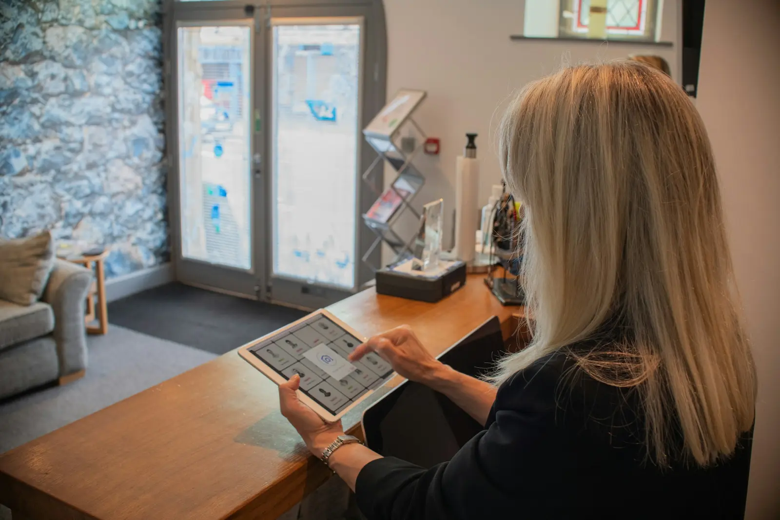 Reception employee using a tablet inside a customer-facing business location
