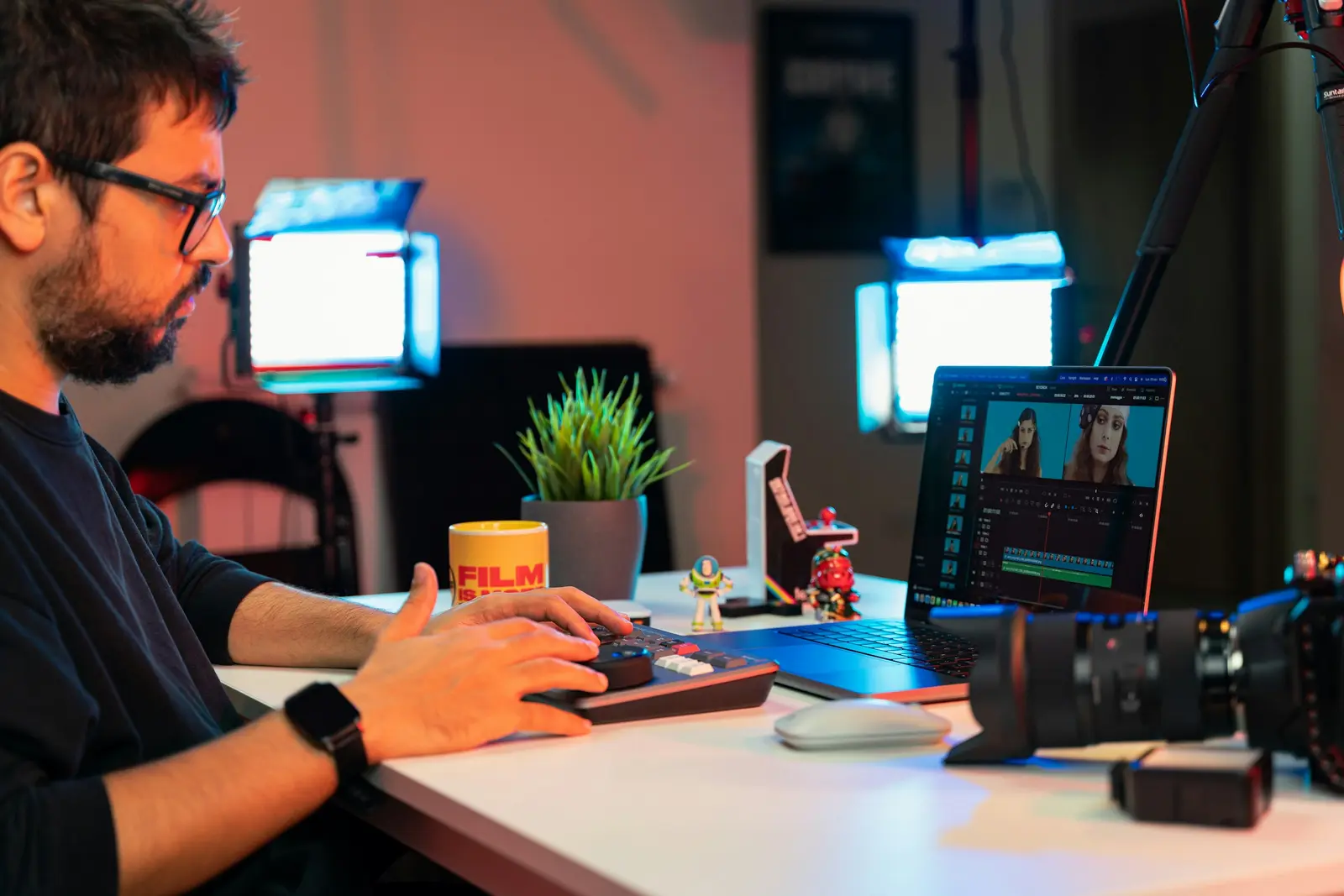 Independent creator editing original media at a camera-equipped workstation