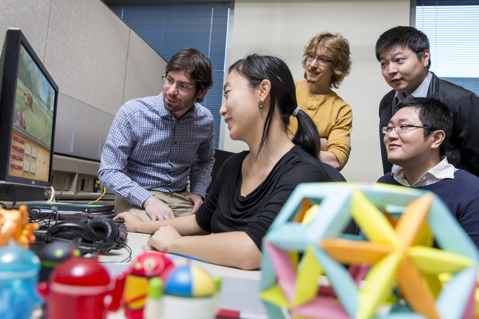 Software research team reviewing a product together at a workstation