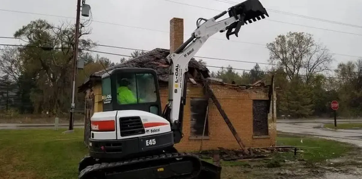 Sol-Cal Construction excavator removing a damaged building