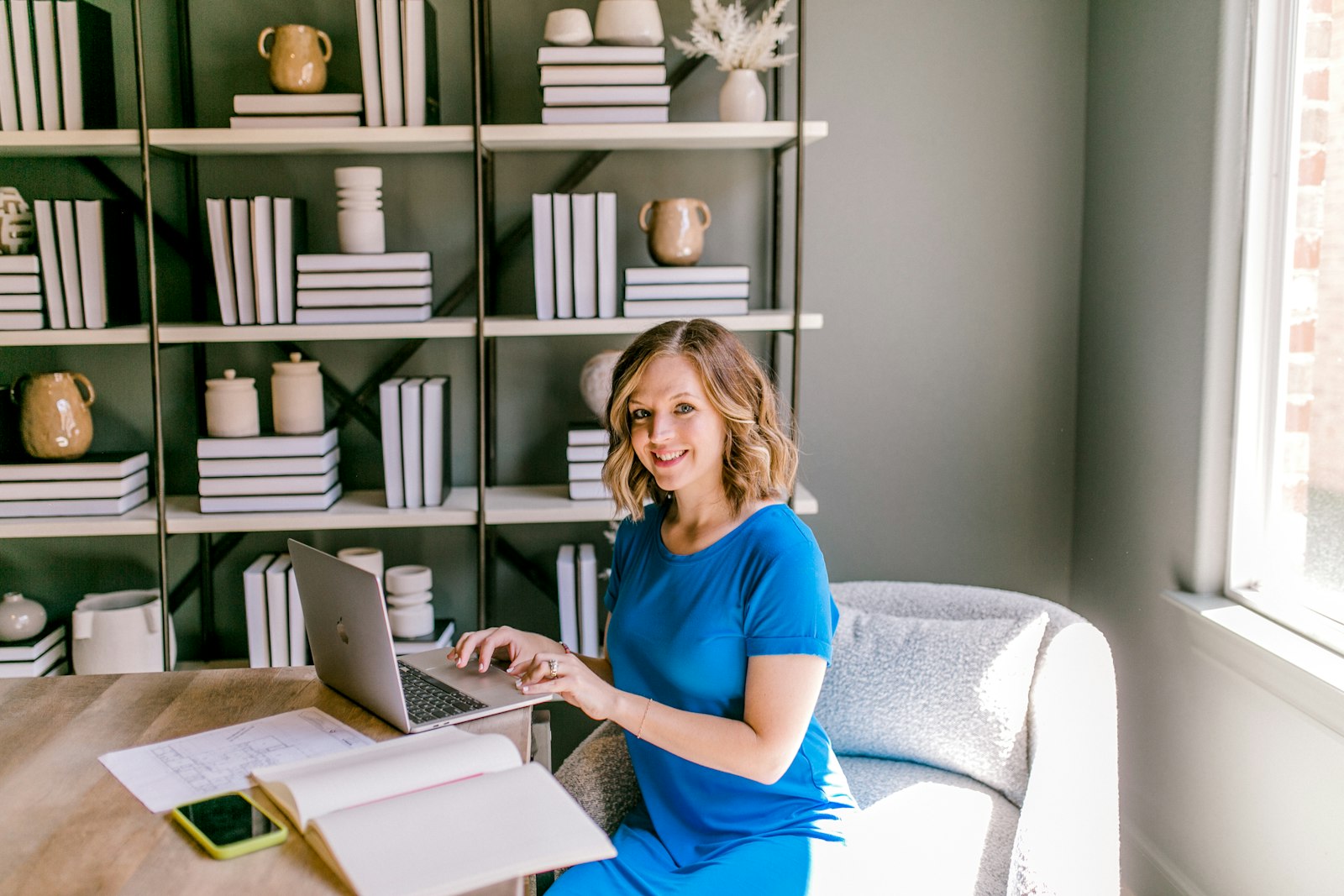 Person at a laptop with planning notes on a desk