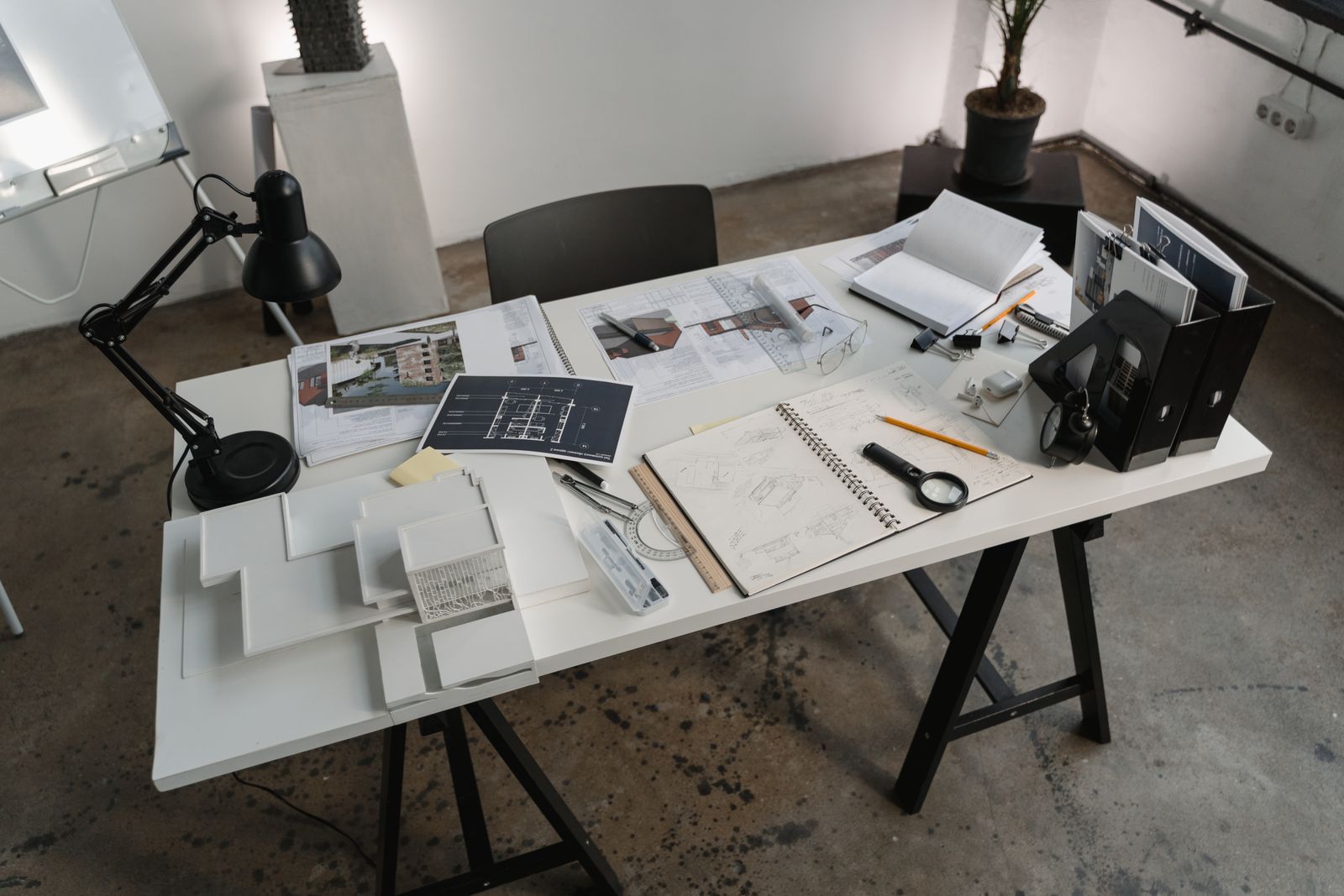 Architectural plans and notes on a worktable