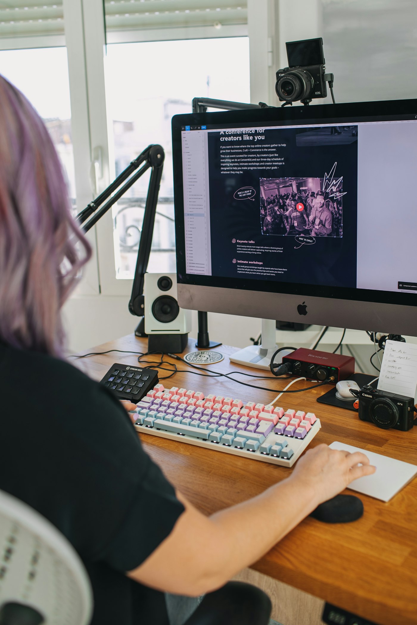 Person working at a computer in a real workspace