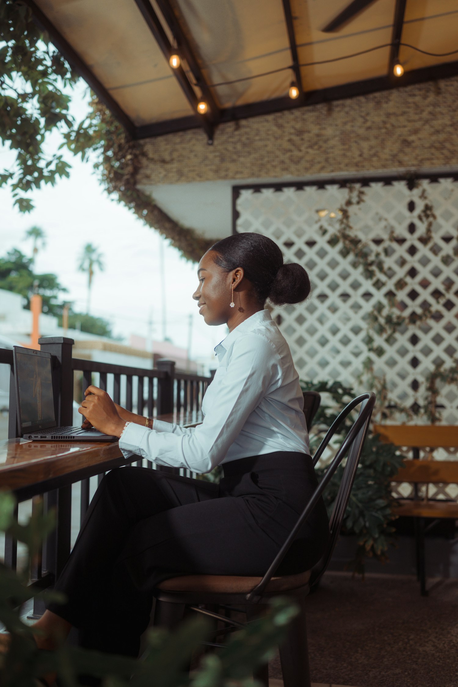 Business owner working on a laptop outdoors